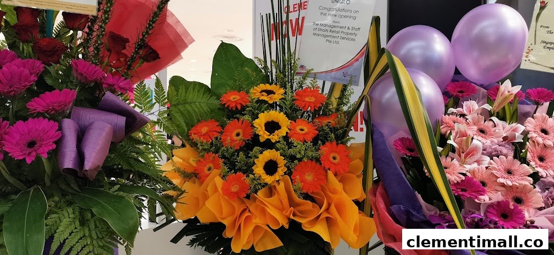 Vibrant floral arrangements and balloons celebrate the grand opening of UNIQLO at The Clementi Mall.