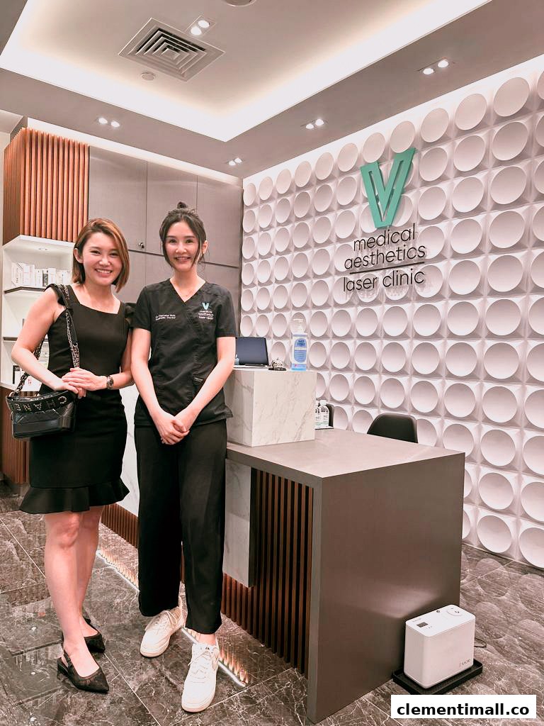 Two women stand smiling in the modern reception area of V Medical Aesthetics & Laser Clinic.