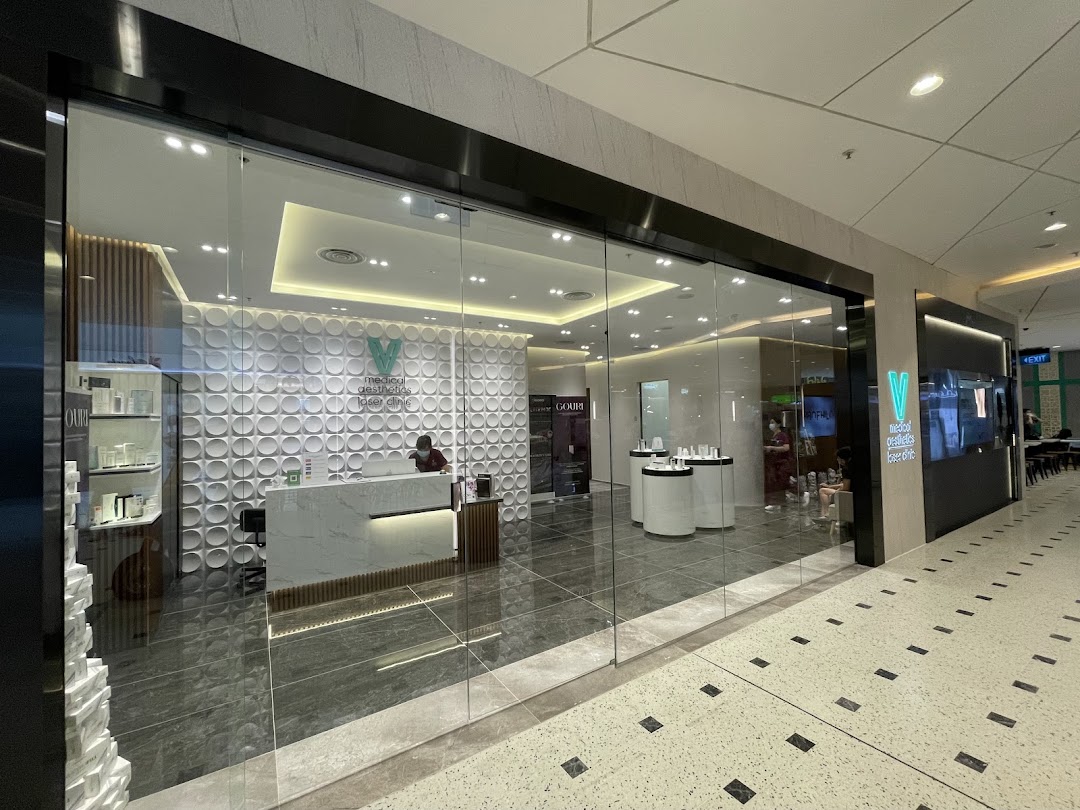 The modern glass shopfront of V Medical Aesthetics & Laser Clinic, featuring a bright reception area.