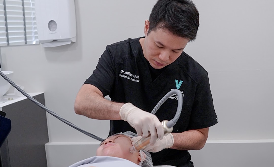 A doctor performs a facial aesthetic treatment on a patient at V Medical Aesthetics & Laser Clinic.