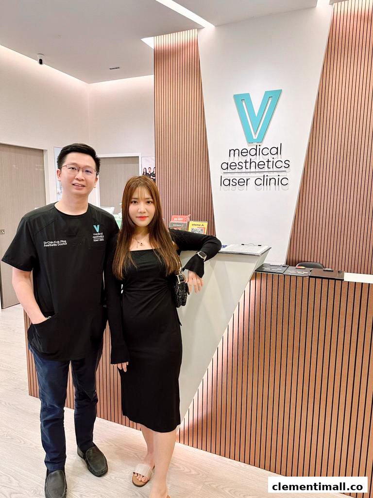 Two individuals stand at the reception of V Medical Aesthetics Laser Clinic.