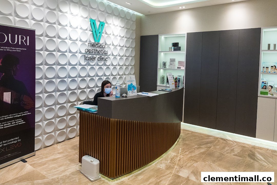 A modern reception area of V Medical Aesthetics & Laser Clinic with a staff member at the desk.