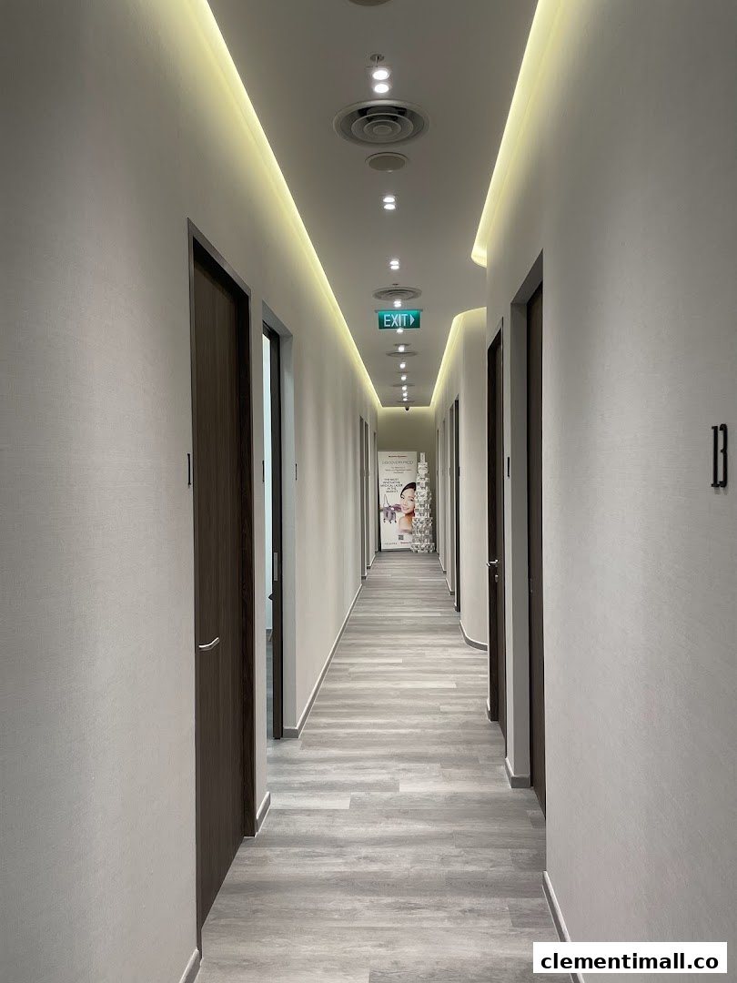 A modern, well-lit hallway with multiple treatment room doors inside the clinic.