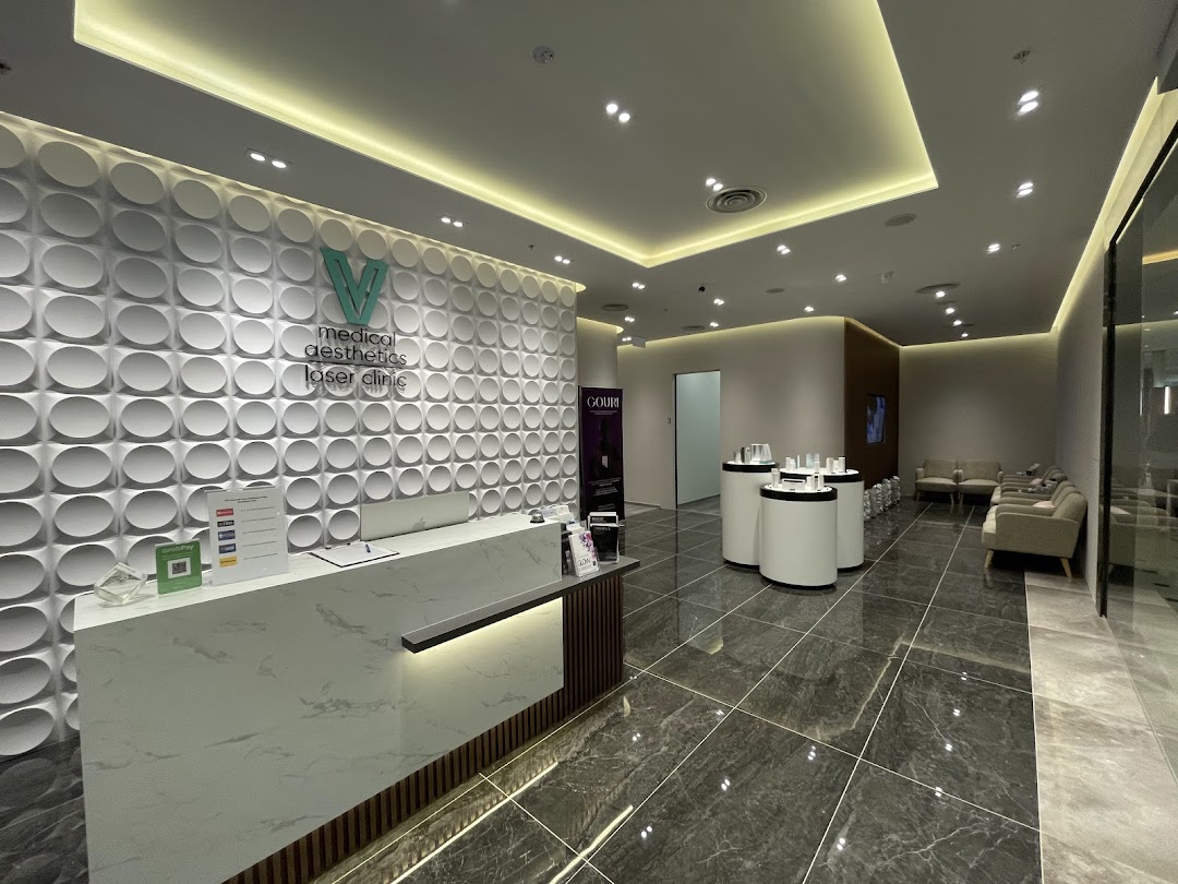 A modern and clean reception area with a waiting lounge at V Medical Aesthetics & Laser Clinic.