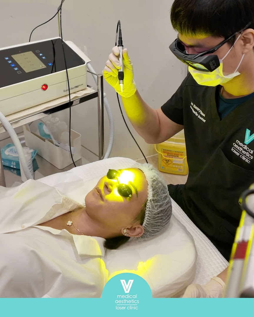 A patient receives a laser aesthetic treatment from a doctor at V Medical Aesthetics & Laser Clinic.