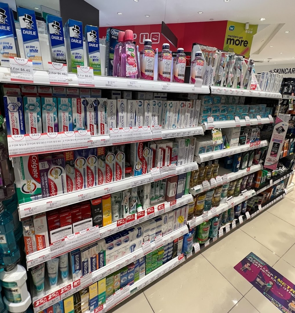 A retail aisle in Watsons pharmacy featuring various oral care products.