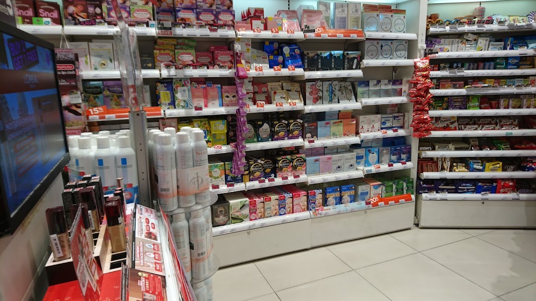 Interior view of a Watsons pharmacy, showcasing shelves filled with health, beauty, and snack products.