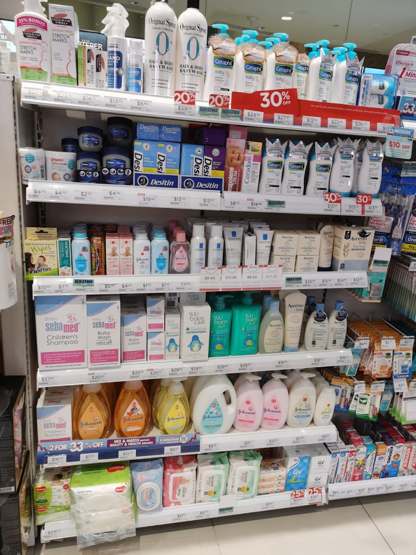 A well-stocked retail shelf displaying various baby care, personal hygiene, and health products.