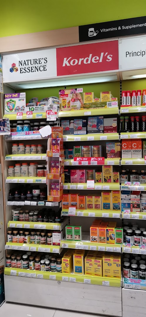 A retail shelf displaying a wide range of vitamins and health supplements from various brands.