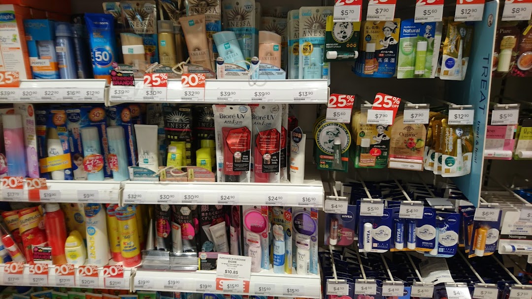 Shelves inside Watsons pharmacy displaying a wide range of skincare, sunscreens, and beauty products.
