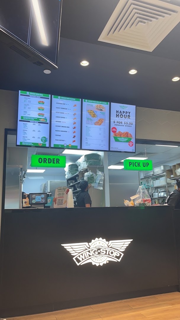 Interior view of Wingstop with digital menu boards displaying various wing combos, flavors, and sides.