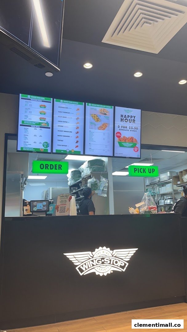 Interior view of Wingstop with digital menu boards displaying various wing combos, flavors, and sides.