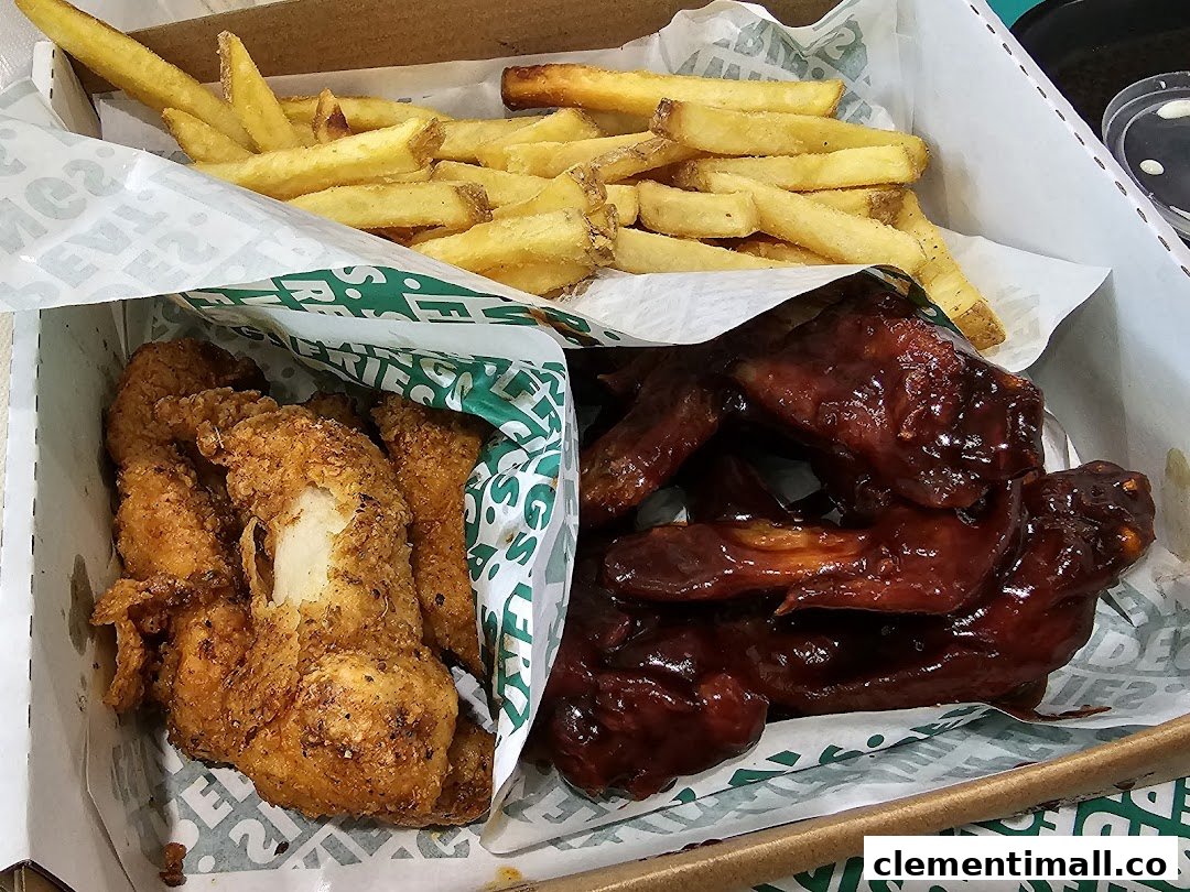 A Wingstop box filled with crispy chicken tenders, saucy chicken wings, and golden fries.