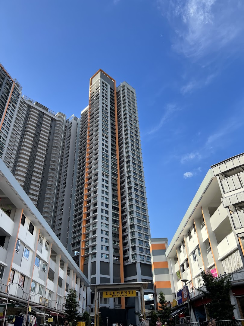 View of tall buildings and lower commercial blocks at Clementi Town Centre under a clear blue sky.