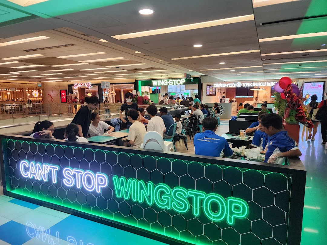 Customers enjoy meals in the vibrant Wingstop dining area at The Clementi Mall.