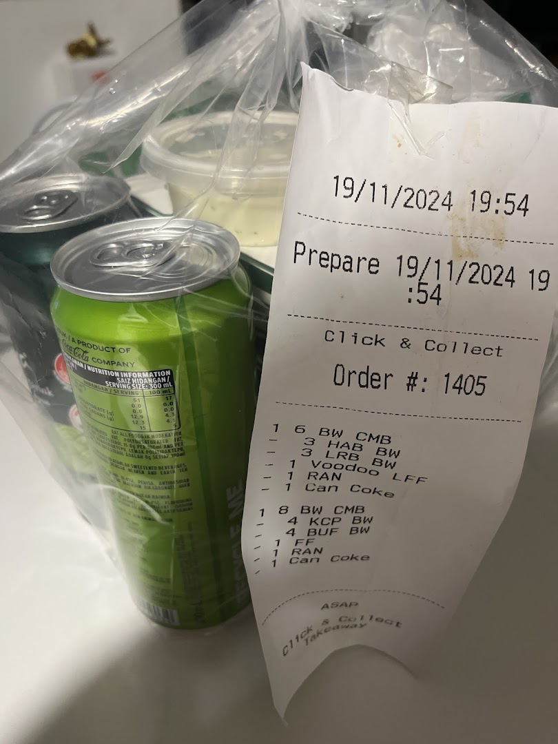 A plastic bag with Wingstop takeaway items, including drinks and a detailed order receipt.