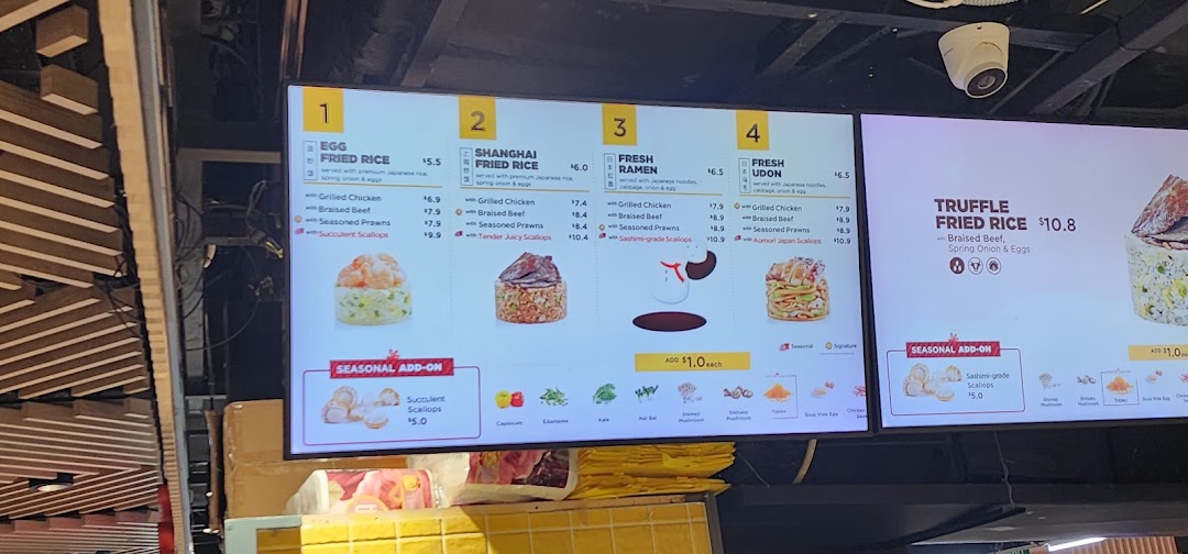 A digital menu board displaying various fried rice and noodle dishes with customizable protein options and add-ons.