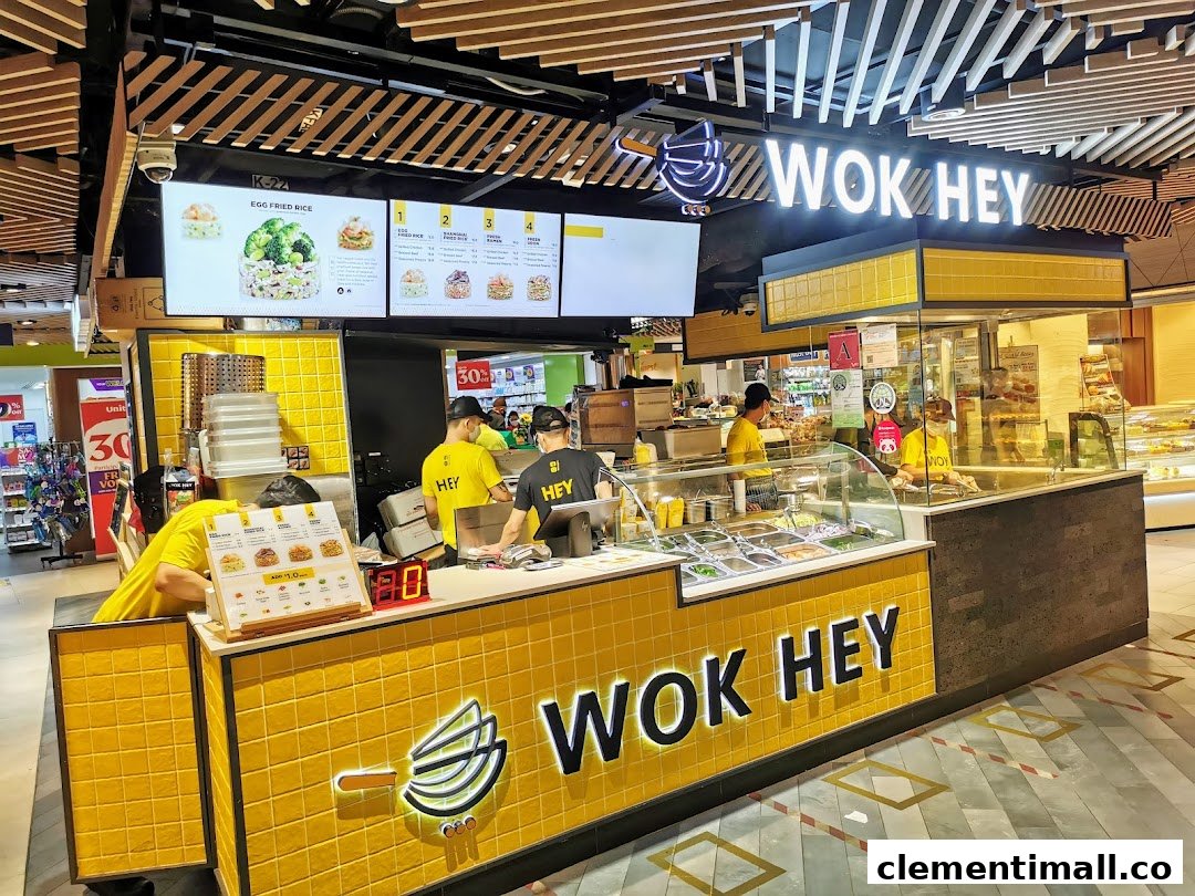 WOK HEY food stall in a mall, featuring staff, counter, and overhead menu displays.