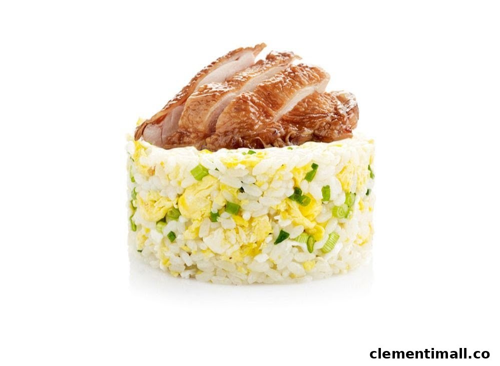 A cylindrical serving of fried rice with egg and spring onions, topped with sliced roasted meat.