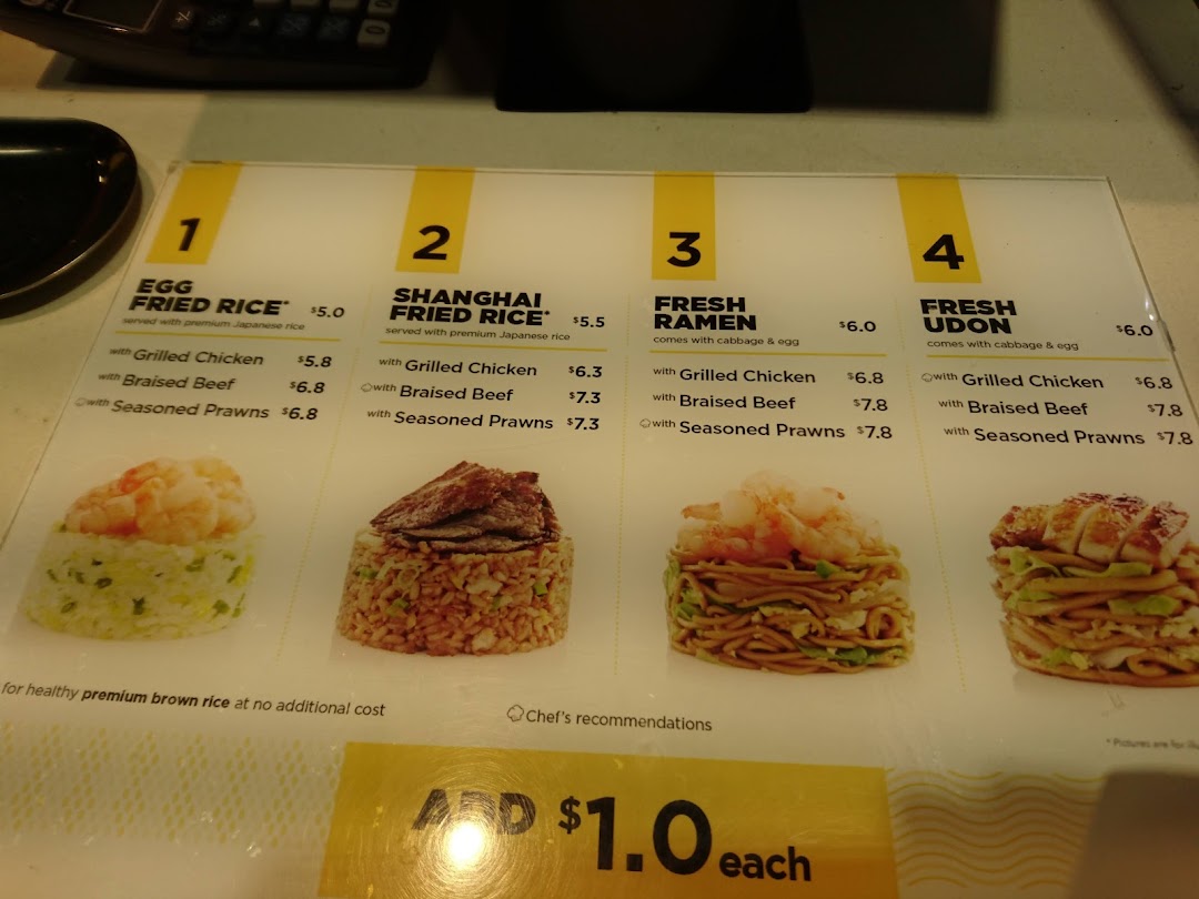 A close-up view of WOK HEY's menu board, showcasing various fried rice and noodle dishes with prices.
