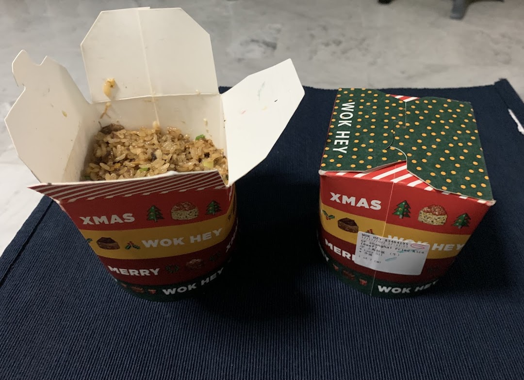 Two Wok Hey takeaway boxes, one open revealing delicious fried rice.