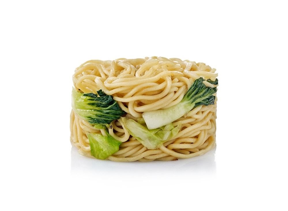 A block of cooked noodles with green bok choy on a white background.