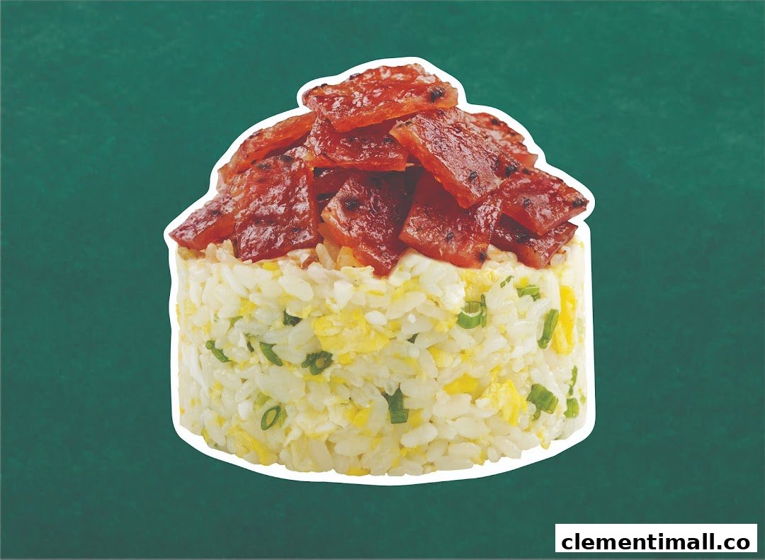 Close-up of Wok Hey's fried rice topped with savory bak kwa slices against a green background.