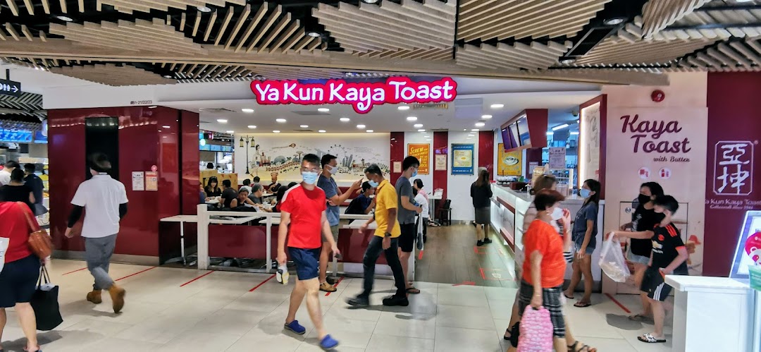 The bustling entrance of Ya Kun Kaya Toast, showcasing its inviting interior and customers.