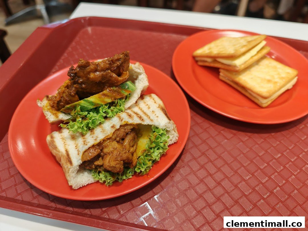 A close-up of a savory toastie with chicken and salad, alongside sweet cream crackers on a red tray.