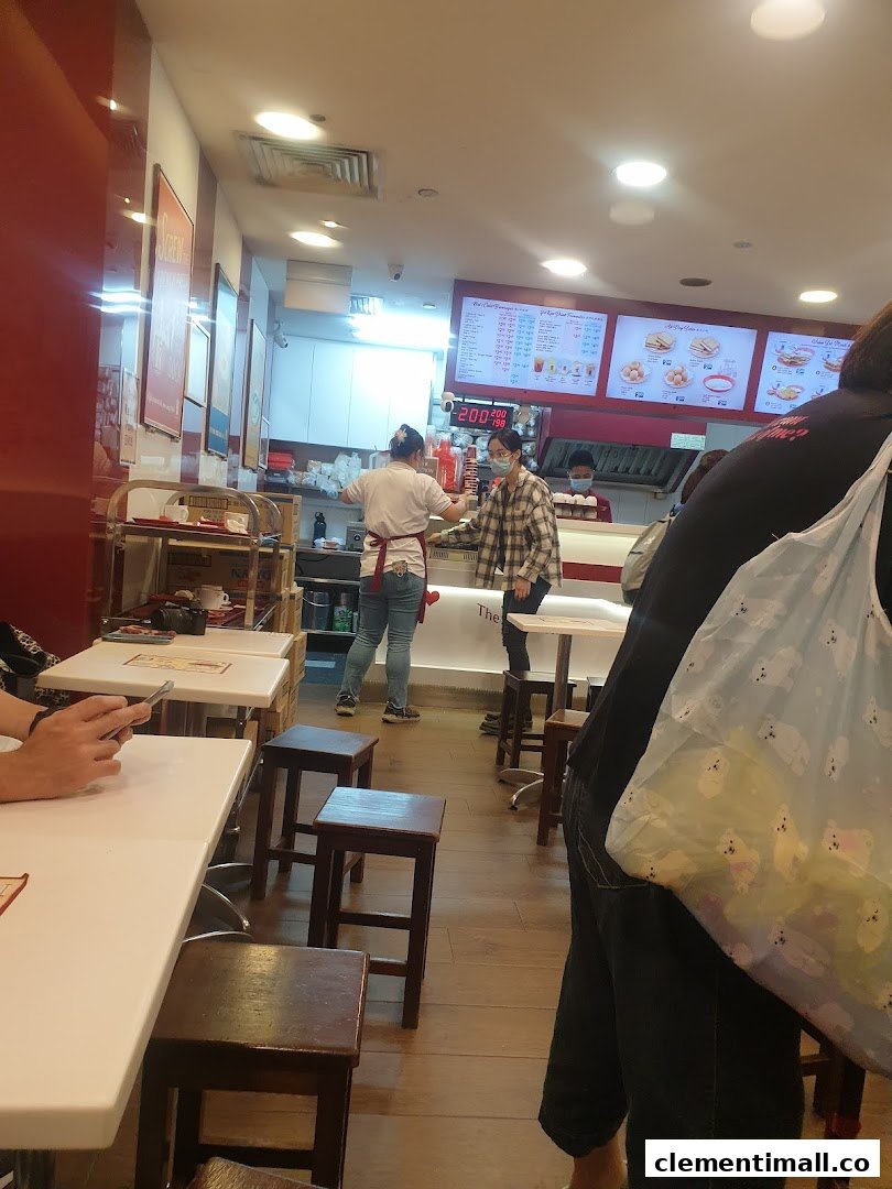 Inside Ya Kun Kaya Toast, customers and staff are visible, with menu boards in the background.