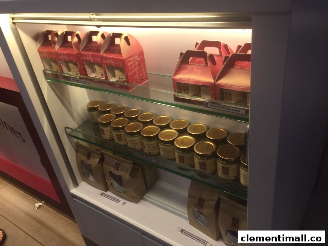 A display case at Ya Kun Kaya Toast featuring jars of kaya spread and coffee packs for sale.