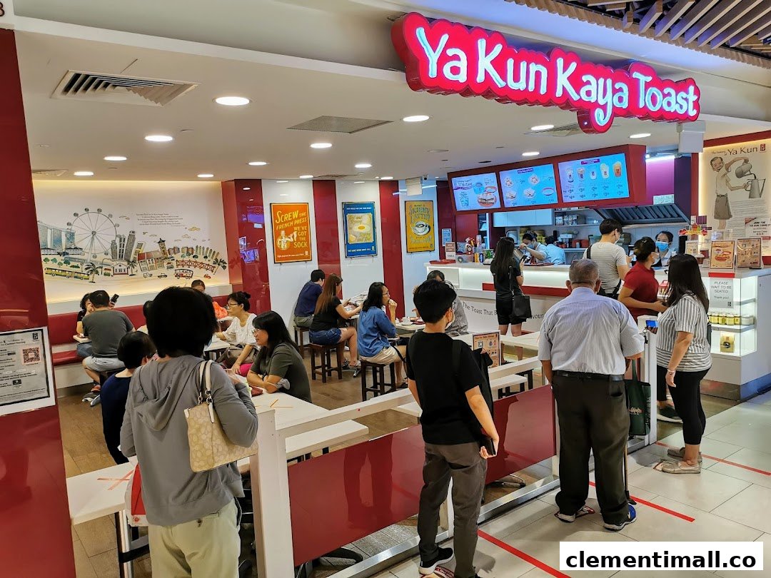 A bustling interior view of Ya Kun Kaya Toast, showing customers ordering and dining in a vibrant setting.