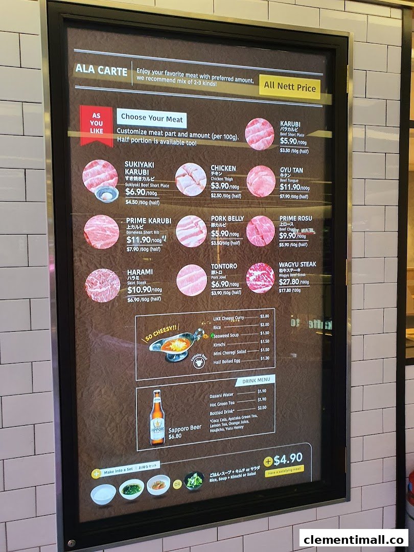A digital menu board displaying various yakiniku meat cuts, side dishes, and drinks with prices.