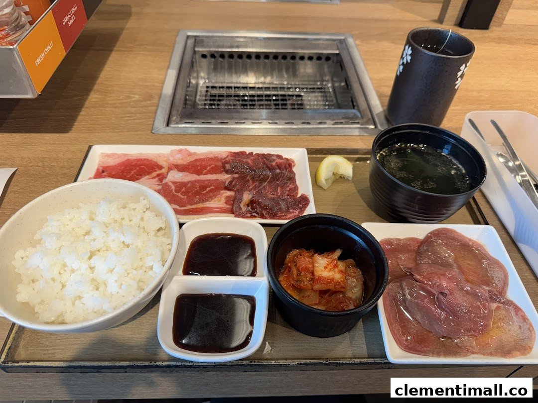 A delicious yakiniku meal set with raw beef, rice, soup, kimchi, and sauces, ready for grilling.