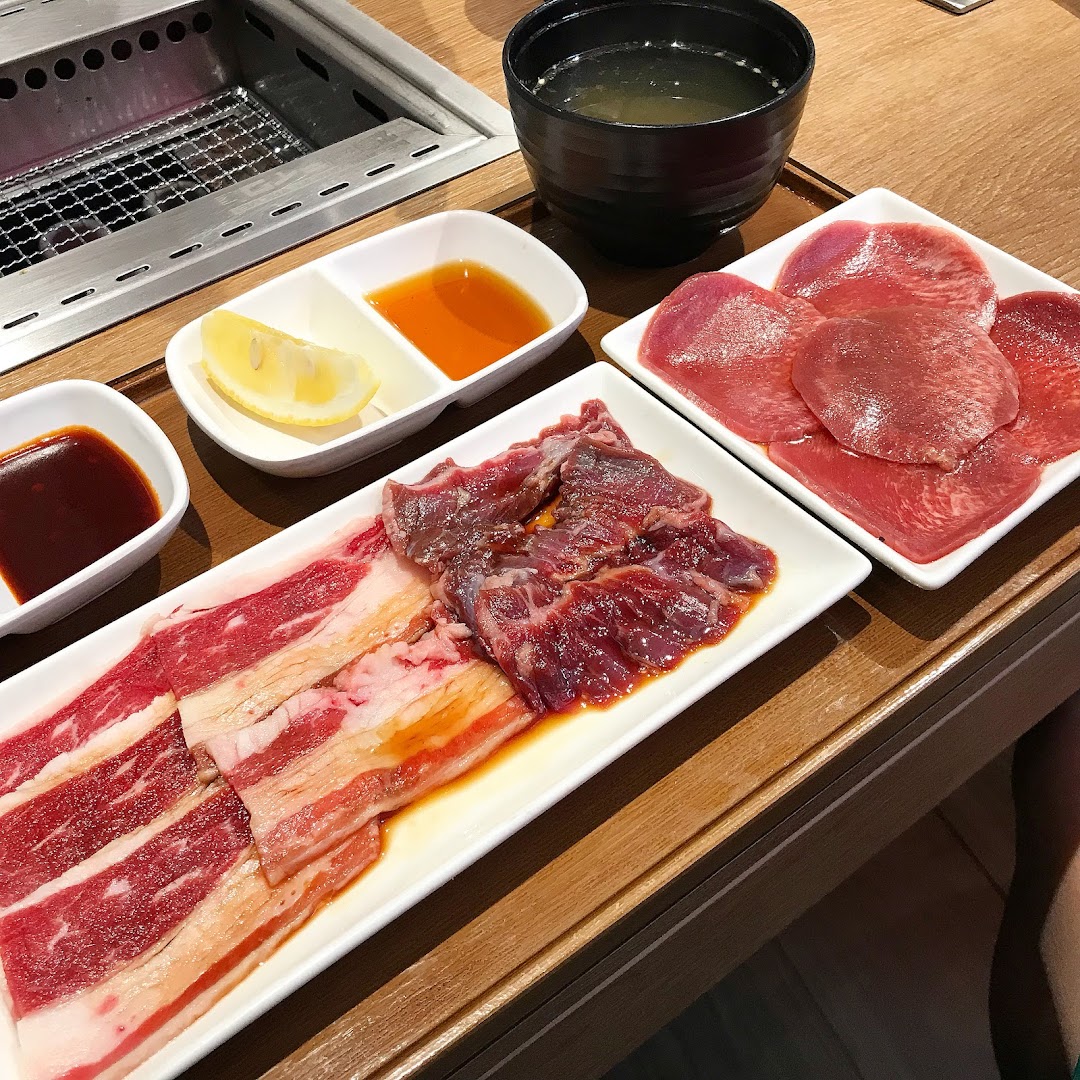 Plates of fresh yakiniku meat, sauces, and soup ready for grilling at Yakiniku Like.