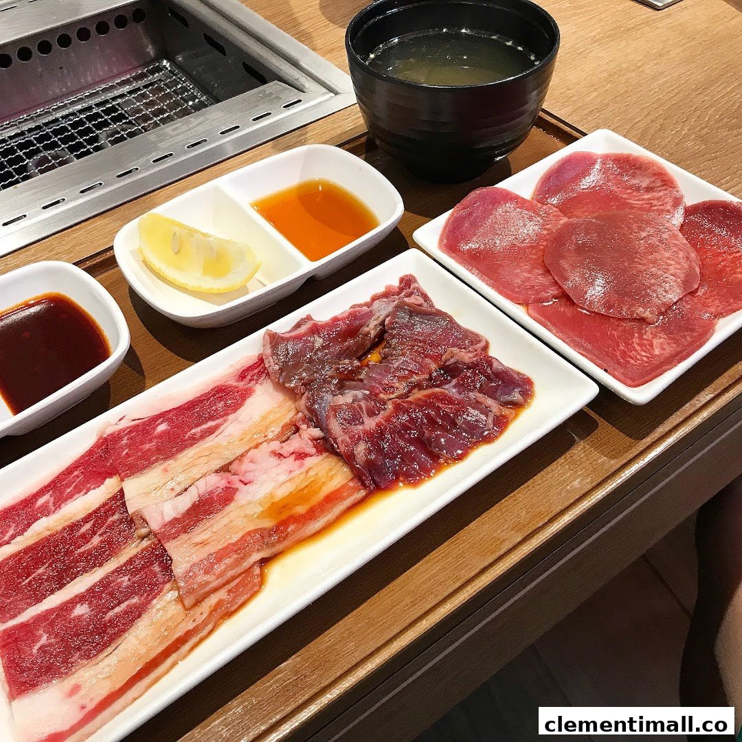 Plates of fresh yakiniku meat, sauces, and soup ready for grilling at Yakiniku Like.