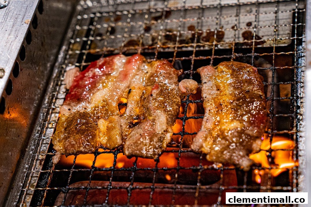 Close-up of sizzling yakiniku beef grilling over hot coals.