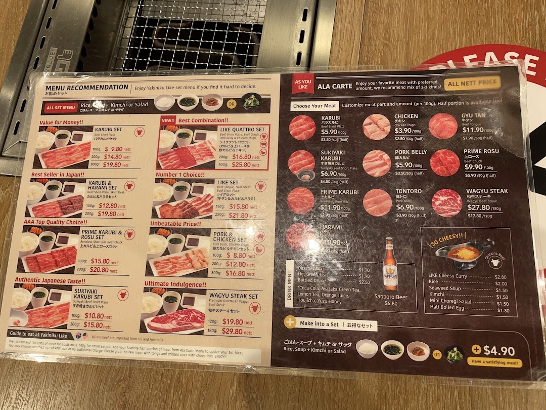 A detailed menu displaying various yakiniku sets, ala carte meat options, drinks, and add-ons.