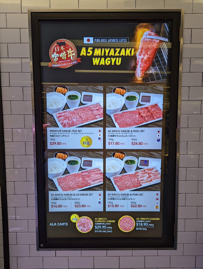 A digital menu board showcasing premium A5 Miyazaki Wagyu beef sets and ala carte options.