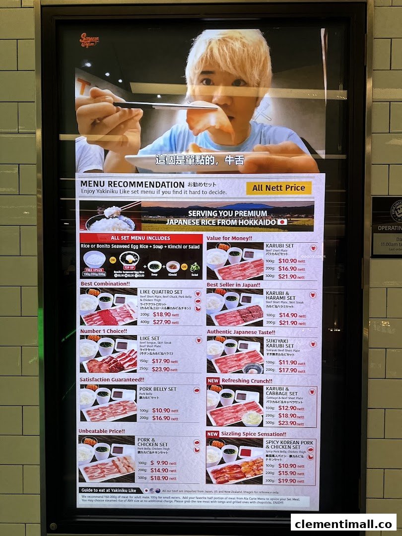 A digital menu board displaying various Yakiniku Like set meals, prices, and promotional details.