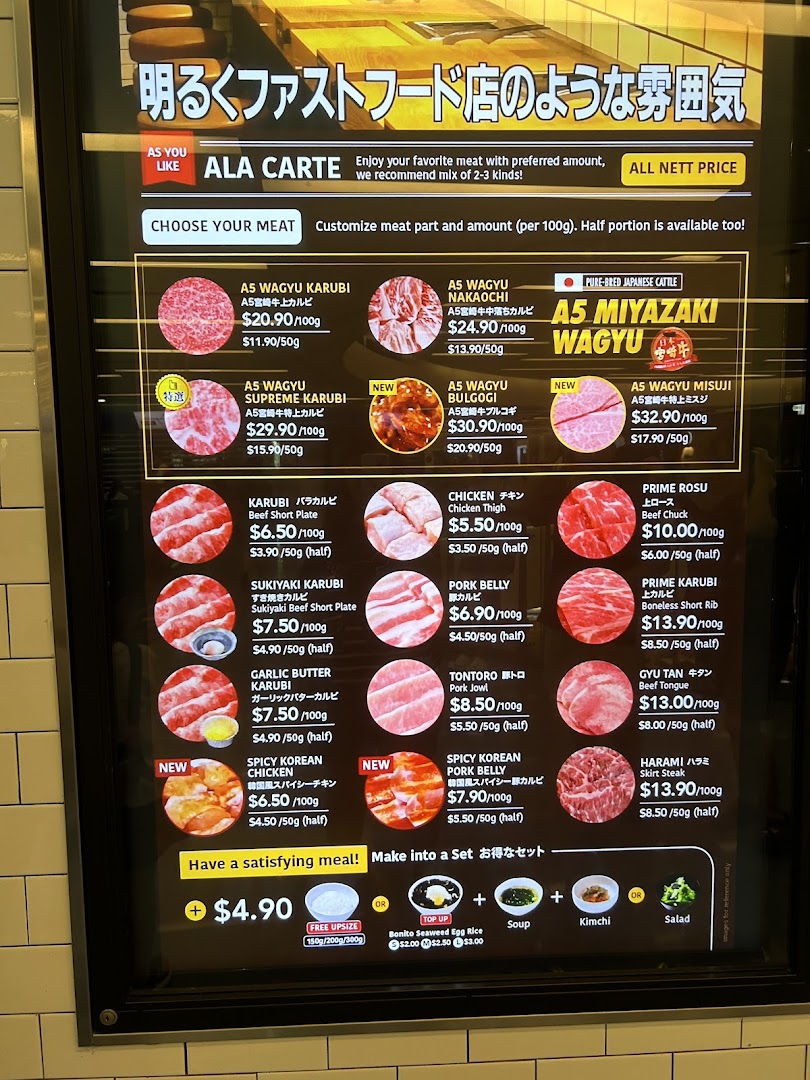 A detailed menu board displaying various cuts of premium wagyu and other meats with prices.