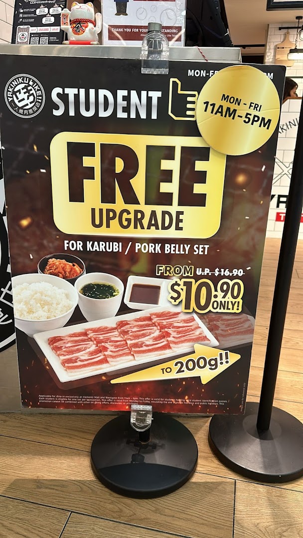 A promotional standee advertising a student free upgrade offer for a Karubi/Pork Belly set.