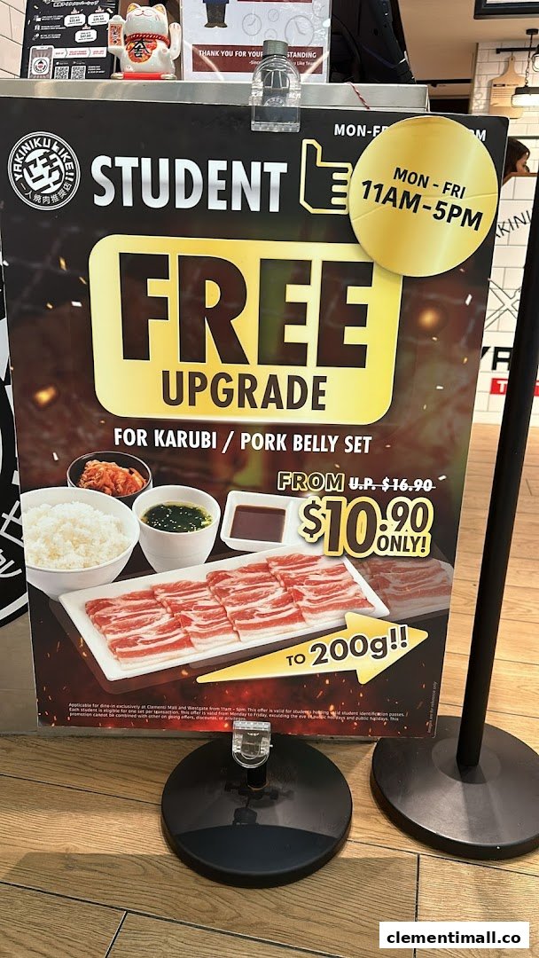 A promotional standee advertising a student free upgrade offer for a Karubi/Pork Belly set.