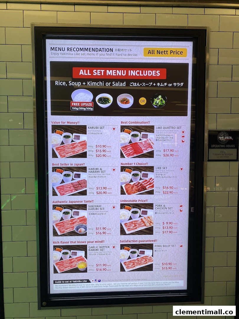 A digital menu board displaying various yakiniku set meals with prices and descriptions.