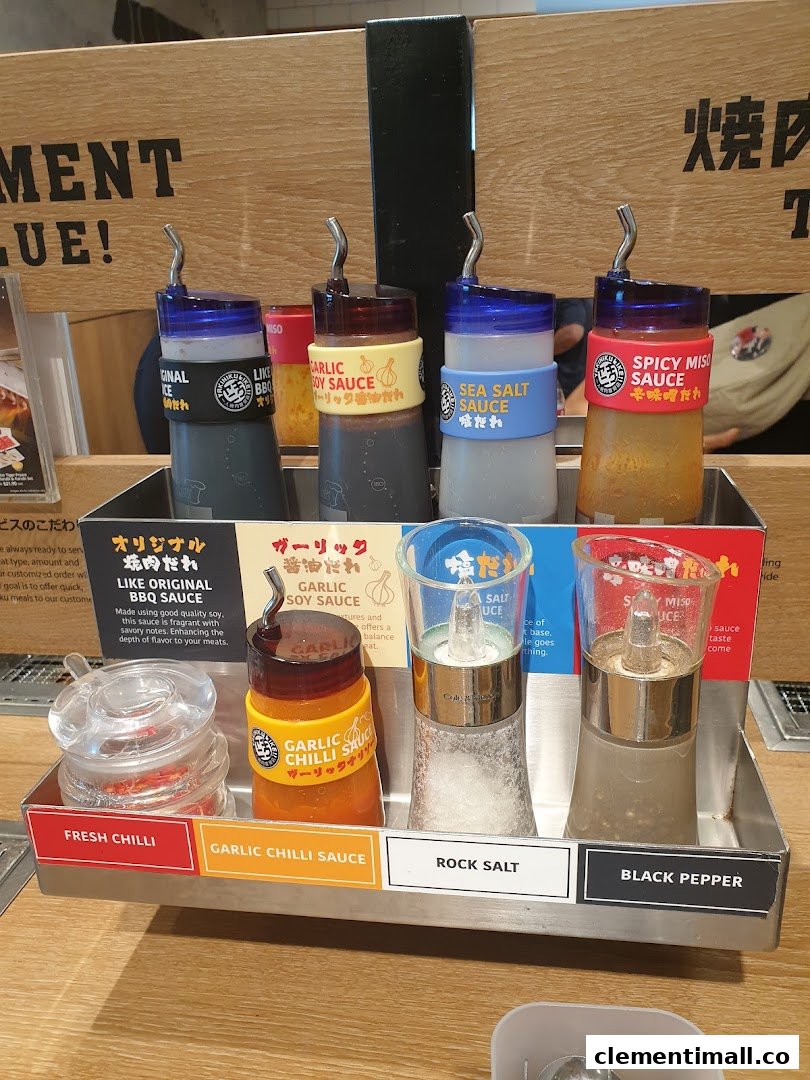 A close-up of various sauces and seasonings available at a Yakiniku Like dining table.