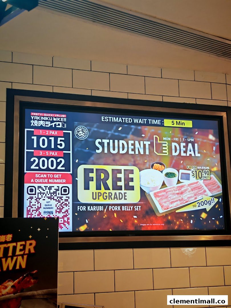 A digital display inside Yakiniku Like, showing queue numbers and a student deal for a free meat upgrade.
