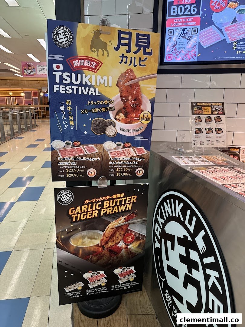 Promotional standees for Yakiniku Like, featuring Tsukimi Festival and Garlic Butter Tiger Prawn specials.