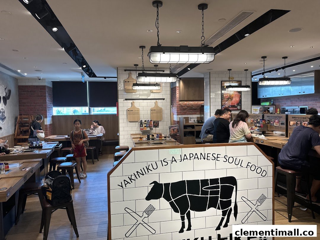 Interior view of Yakiniku Like, showing customers dining at tables and a counter, with a prominent 'Yakiniku is a Japanese Soul Food' sign.