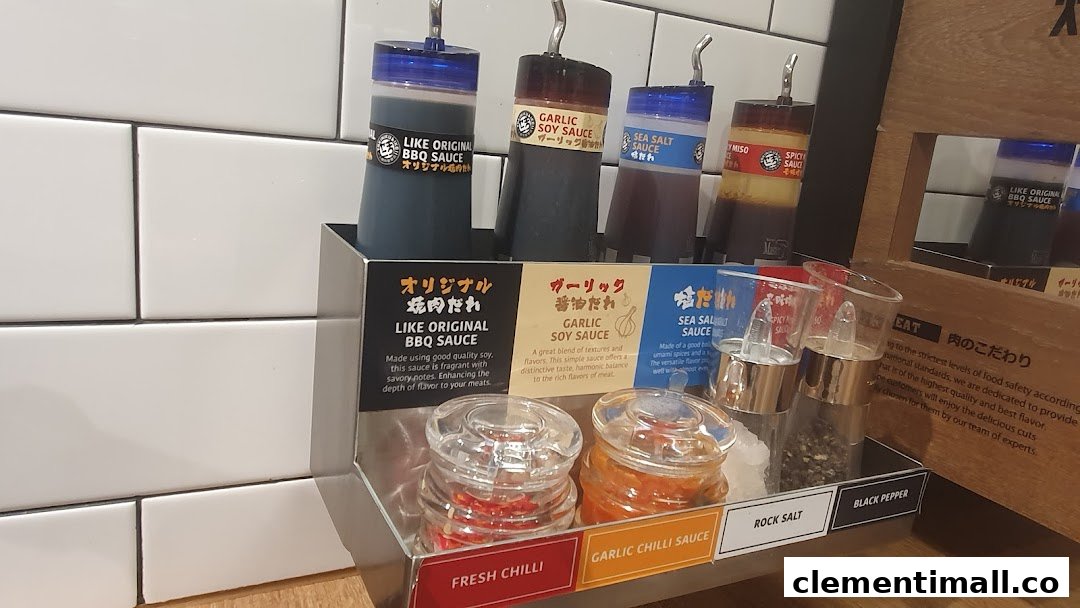 A close-up of a condiment station featuring various sauces and seasonings for yakiniku.