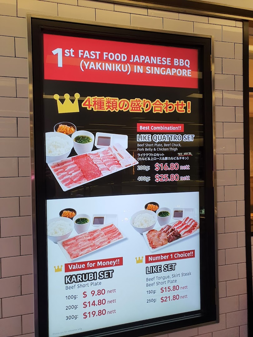 A digital menu board displaying various Japanese BBQ sets with prices and descriptions.